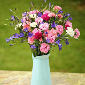 Cornish Pinks and Brodiaea bouquet featuring Pinks in shades of pink and white and blue Brodiaea. Vase not included.